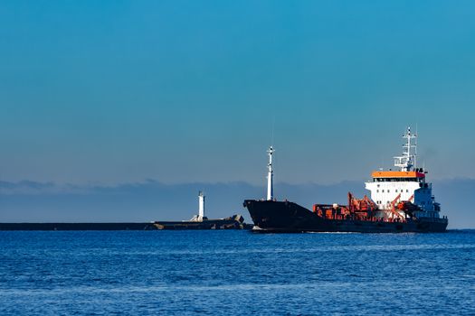 Black cargo oil tanker sailing in still water from Baltic sea