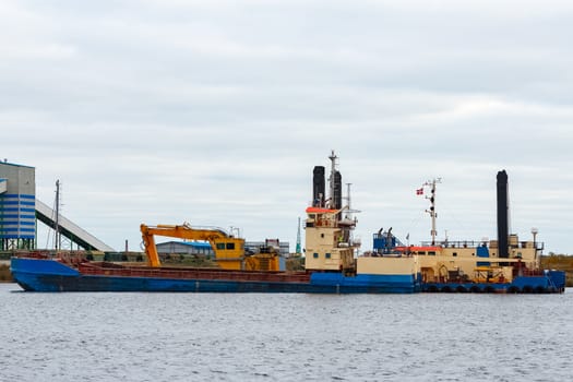 Blue cargo ship loading in the port of Riga, Europe