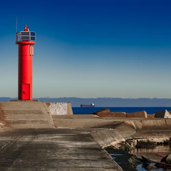 Red lighthouse on breakwater dam in Riga, Europe