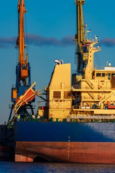 Blue cargo ship loading in the port of Riga, Europe