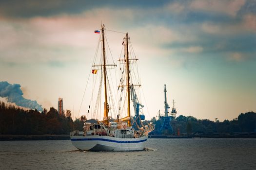 White sailing ship coming from Baltic sea and entering Riga