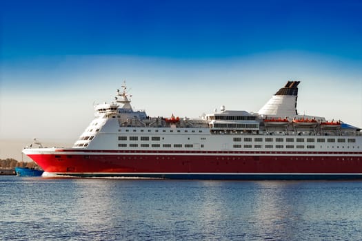 Red cruise liner. Passenger ferry ship sailing in still water