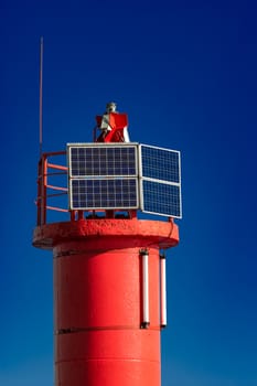 Red lighthouse against blue sky in Riga, Europe