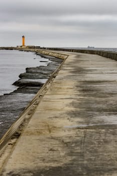 Breakwater dam with yellow lighthouse in Riga, Europe