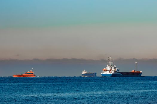 Blue cargo ship leaving Riga and entering Baltic sea