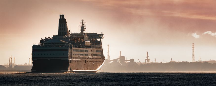 Big cruise liner. Passenger ferry ship entering Riga at morning