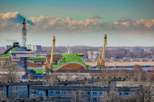 Green cruise liner. Passenger ferry sailing past the Riga city