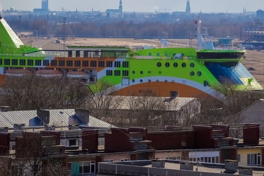 Green cruise liner. Passenger ferry sailing past the Riga city