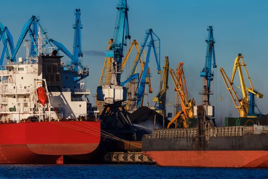 Red cargo ship loading in the port of Riga, Europe