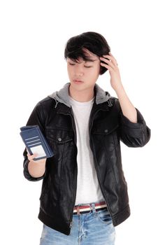 A surprised Asian man looking at his cell phone and is worried what
he is seeing at his phone, isolated for white background.
