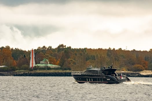 Black elite speed motor boat entering Riga