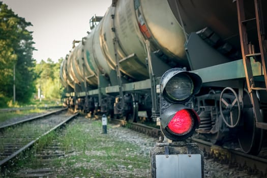 Railroad traffic light and freight train on behind