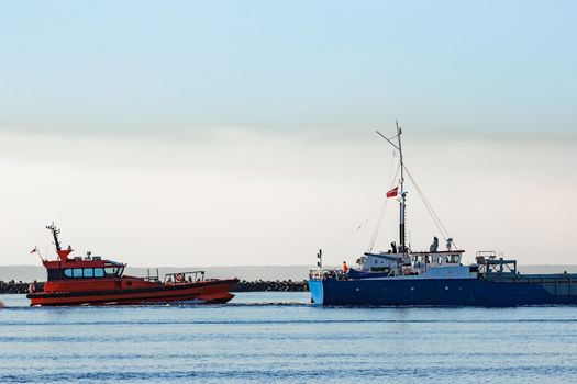 Blue cargo ship leaving Riga and entering Baltic sea