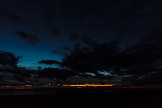 Dark blue cloudy sky over the Baltic sea at night