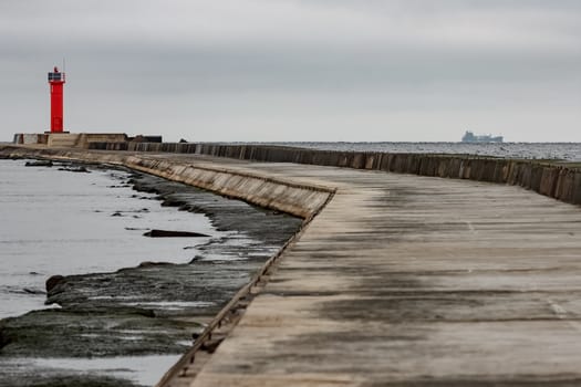 Breakwater dam with red lighthouse in Riga, Europe