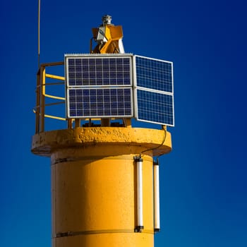 Yellow lighthouse against blue sky in Riga, Europe