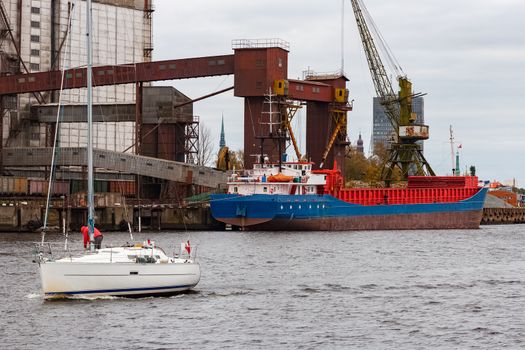 Blue cargo ship loading in the port of Riga, Europe