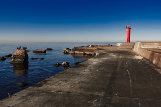 Red lighthouse on breakwater dam in Riga, Europe