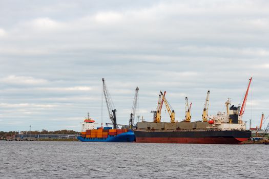 Black cargo ship loading in the port of Riga, Europe