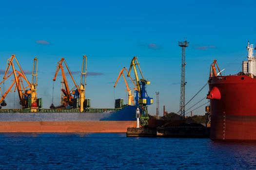 Blue cargo ship loading in the port of Riga, Europe