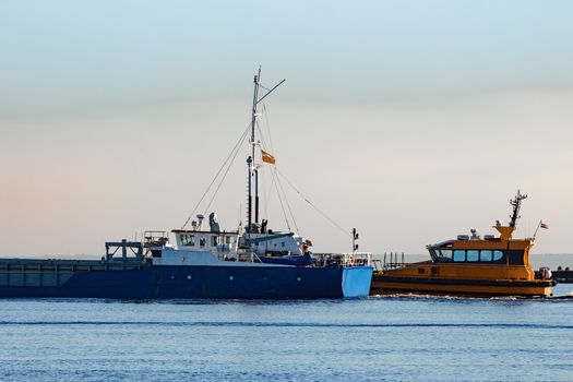 Blue cargo ship leaving Riga and entering Baltic sea