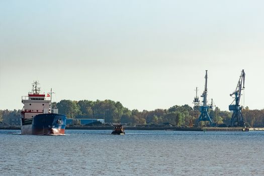 Blue cargo ship leaving the port of Riga