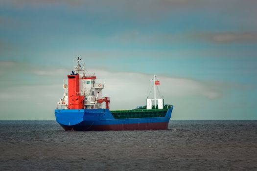 Blue cargo ship entering the Baltic sea. Riga, Europe