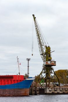 Blue cargo ship loading in the port of Riga, Europe