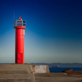 Red lighthouse on breakwater dam in Riga, Europe