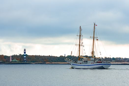 White sailing ship coming from Baltic sea and entering Riga