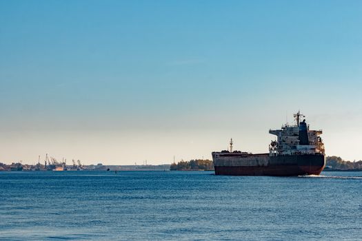 Black cargo ship entering Riga, Europe