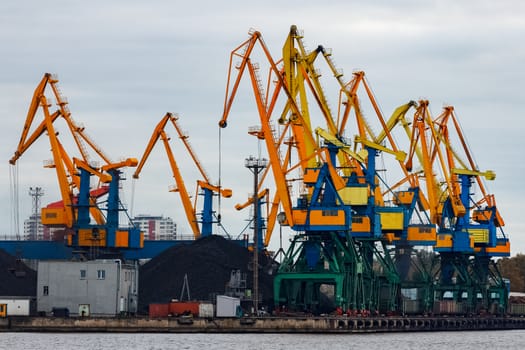 Yellow cargo cranes in the port of Riga, Europe