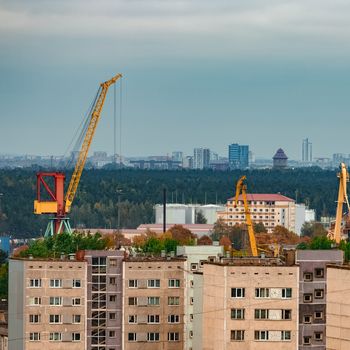 Residential area in Riga with soviet houses and cargo cranes