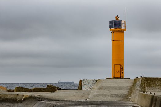 Breakwater dam with yellow lighthouse in Riga, Europe