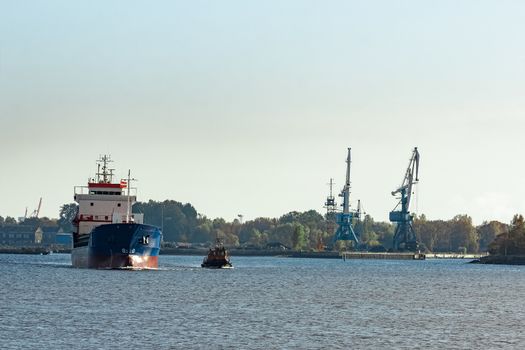 Blue cargo ship leaving the port of Riga