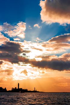 Golden sunset sky over the town silhouette