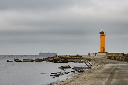 Breakwater dam with yellow lighthouse in Riga, Europe