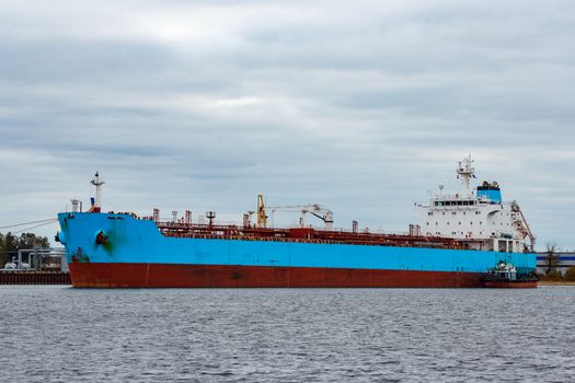 Blue cargo ship loading in the port of Riga, Europe