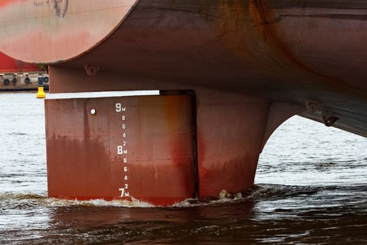 Big red cargo ships stern close up