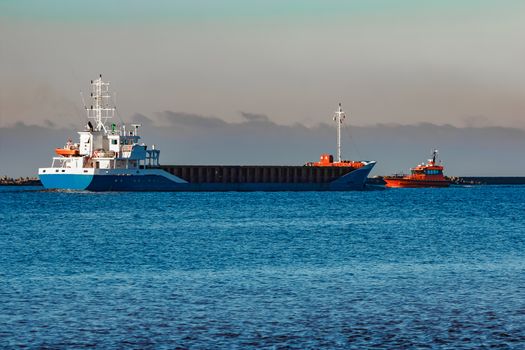 Blue cargo ship leaving Riga and entering Baltic sea