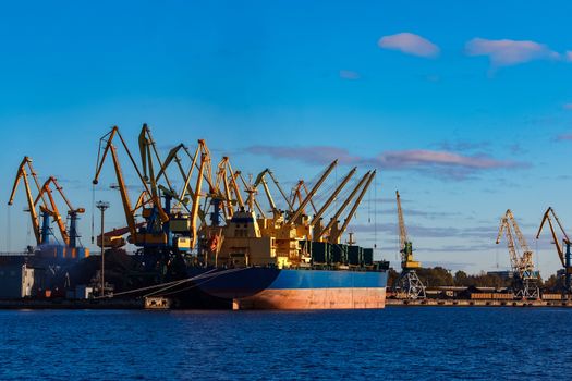 Blue cargo ship loading in the port of Riga, Europe