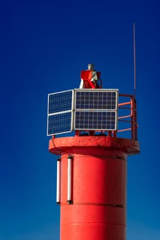 Red lighthouse against blue sky in Riga, Europe