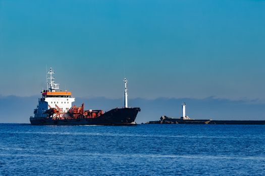 Black cargo oil tanker sailing in still water from Baltic sea