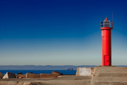 Red lighthouse on breakwater dam in Riga, Europe