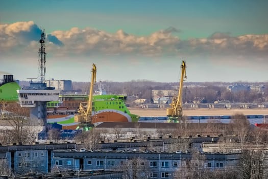 Green cruise liner. Passenger ferry sailing past the Riga city