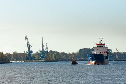 Blue cargo ship leaving the port of Riga