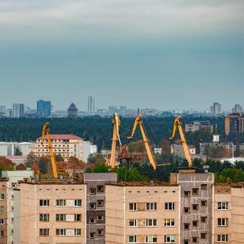 Residential area in Riga with soviet houses and cargo cranes