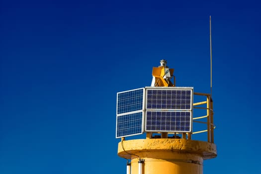 Yellow lighthouse against blue sky in Riga, Europe