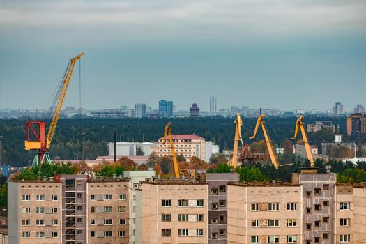 Residential area in Riga with soviet houses and cargo cranes