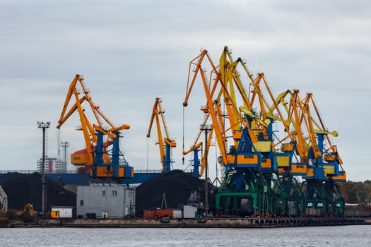 Yellow cargo cranes in the port of Riga, Europe